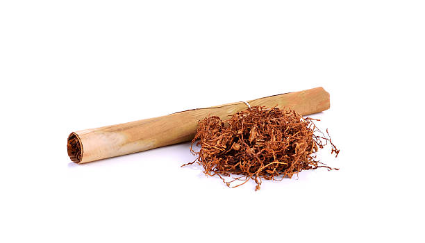 istock Tobacco pile and cigarette on white background 621921896