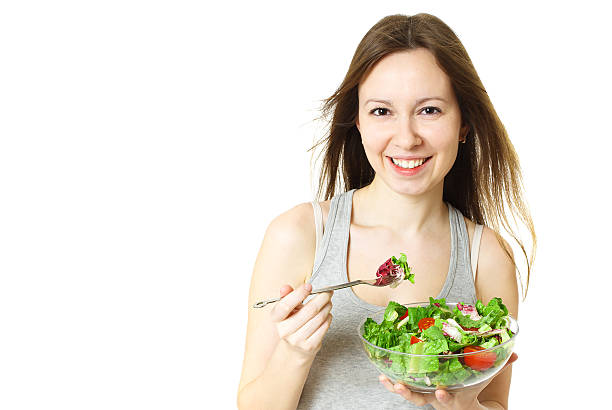 istock Happy young woman eating salad. 621923358