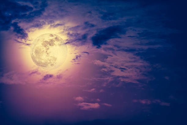 istock Nighttime sky with clouds and bright full moon with shiny. 621924886