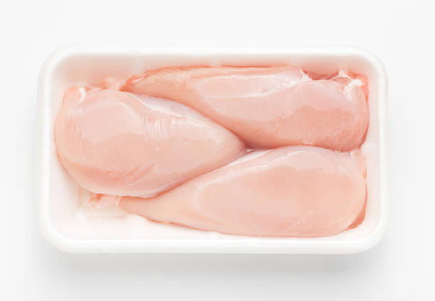 istock Meat. Raw chicken fillet package isolated on white background. Top 621925598