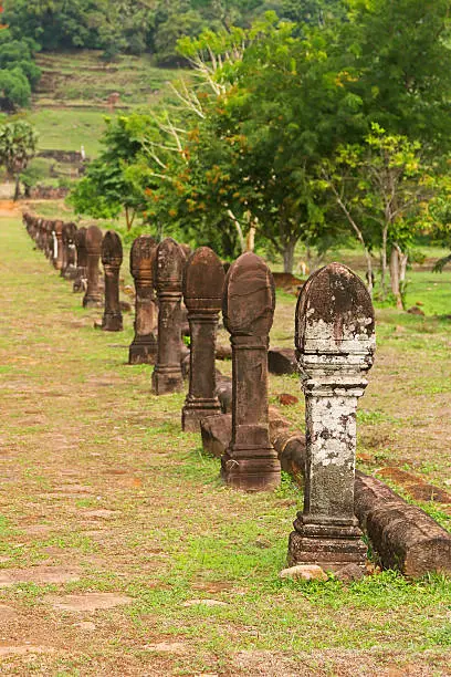 Photo of Stone carved poles columns along path at Vat Phou, Laos