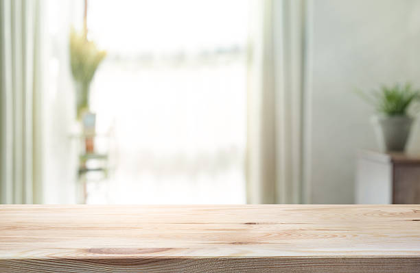 istock Empty wood table top on blur of curtain window background. 621925982