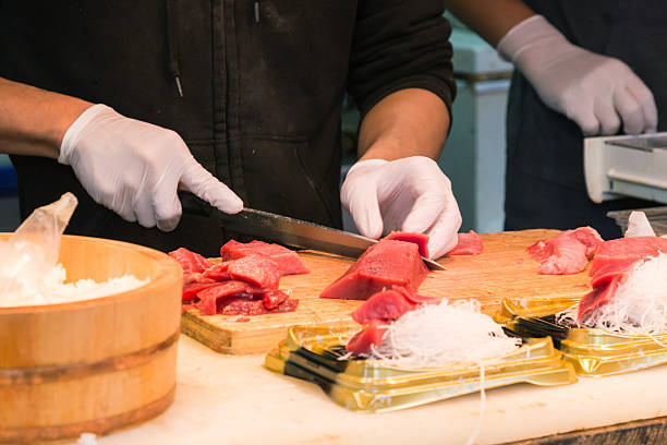 japanese chef cutting tuna fish for sushi and sashimi menu