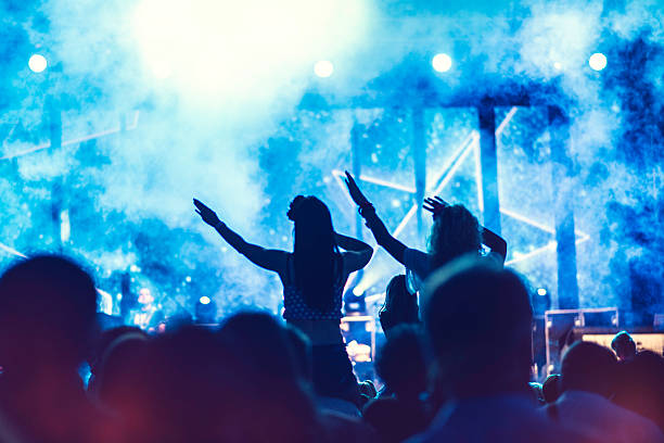 istock Girls sitting on shoulders at a concert 621927372