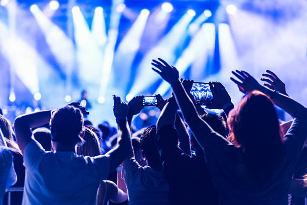 Crowd filming a concert with their smartphones