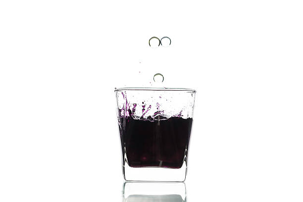 istock Marble drop in glass with reflection on white background 621927720