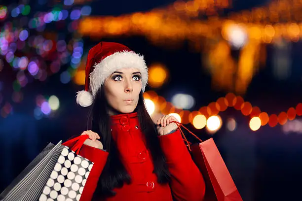 Photo of Surprised Christmas Woman With Shopping Bags