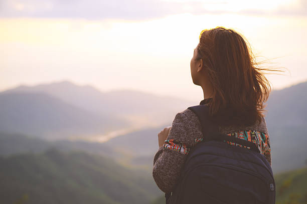 istock Hipster young girl with backpack enjoying sunrise 621929638