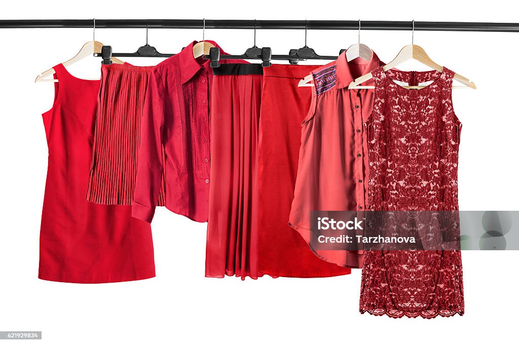 Red clothes on clothes rack Group of red clothes on clothes rack isolated over white Women Stock Photo