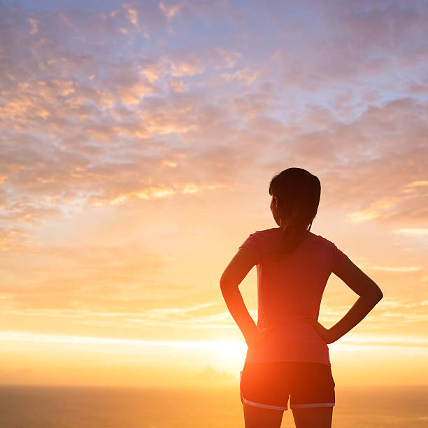 istock silhouette of woman with sunlight 621929890