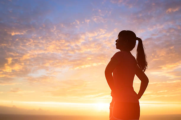 istock silhouette of woman with sunlight 621929918