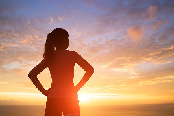 istock silhouette of woman with sunlight 621929950