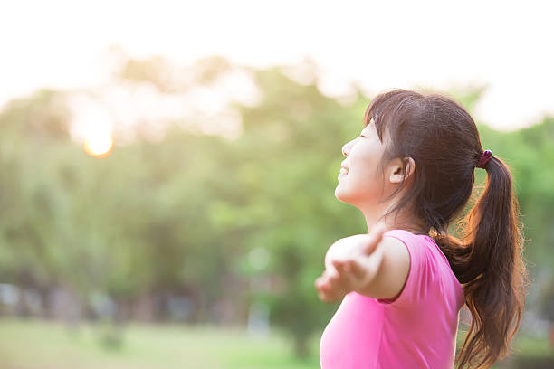 istock young woman raising her arms 621930300