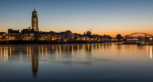 Deventer at the IJssel with Church Deventer, The Netherlands - October 9, 2016: Deventer at the IJssel in the morning during blue hour with the Great Church or Lebuinukerk and Bridge in the province Overijssel, The Netherlands. deventer photos stock pictures, royalty-free photos & images