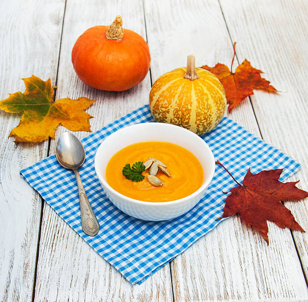 istock Pumpkin soup with fresh pumpkins 621933300