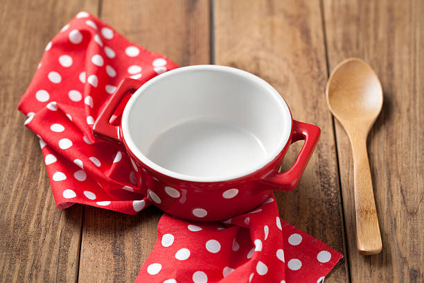 istock Empty bowl and spoon with napkin on wooden table 621935402