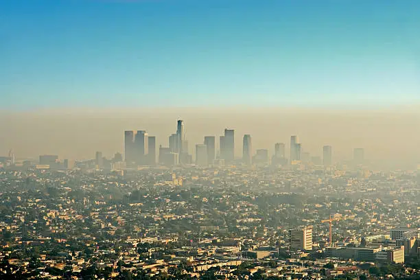 Wide shot of the downtown Los Angeles skyline bathed in smog. View from Griffith Park