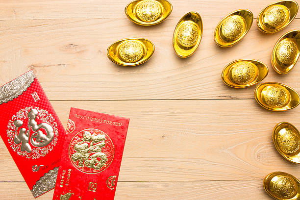 istock Chinese red envelope and gold ingot in wood 621937866