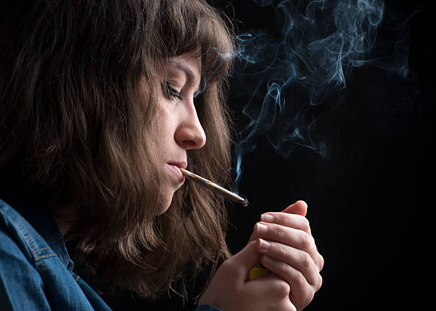 istock Young woman smokes a cigarette 621938530