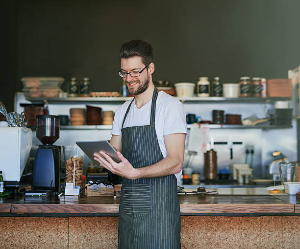 istock Managing his coffee shop online 621939700