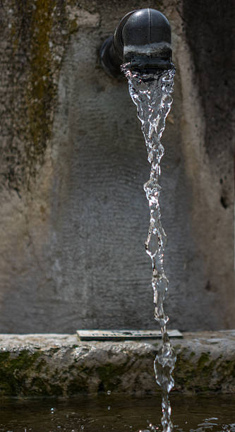 istock The jet of drinking water from the spring crane 621971812