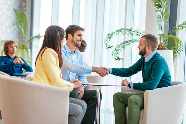 istock Business people handshake after discussion in hotel lobby 621972174