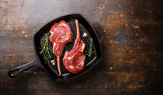 Raw fresh meat Veal ribs on frying Grill pan on wooden background copy space