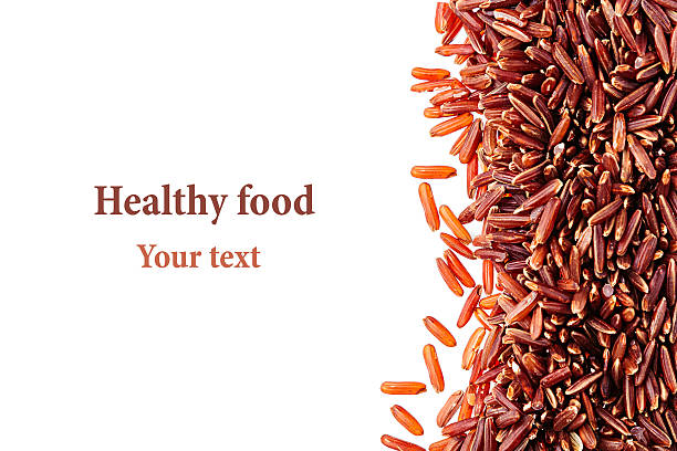 Red rice close-up border on white background. Border of red rice close-up  on white background. Isolated. Decorative frame of wild brown unpolished rice. genmai stock pictures, royalty-free photos & images