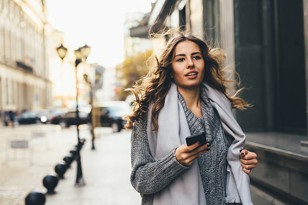 istock Woman texting outdoors 621975922