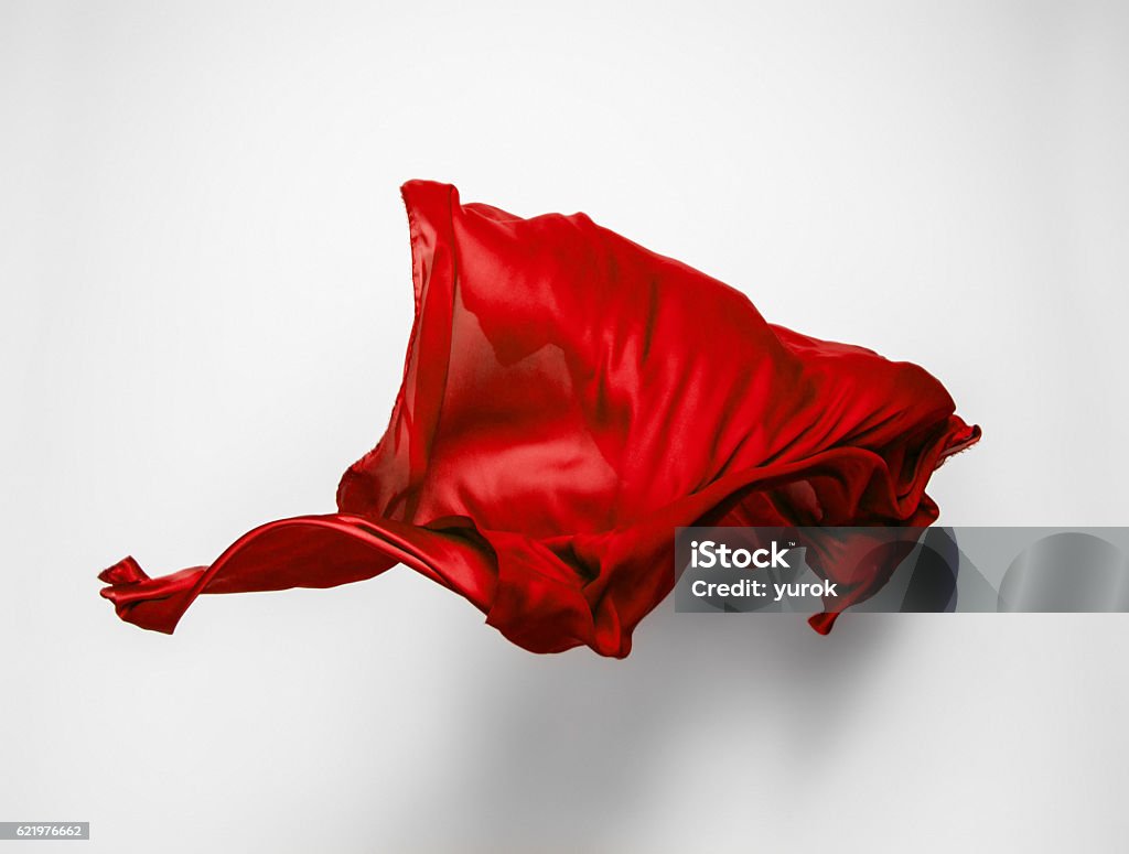 abstract red fabric in motion piece of red fabric soaring, art object, design element Textile Stock Photo