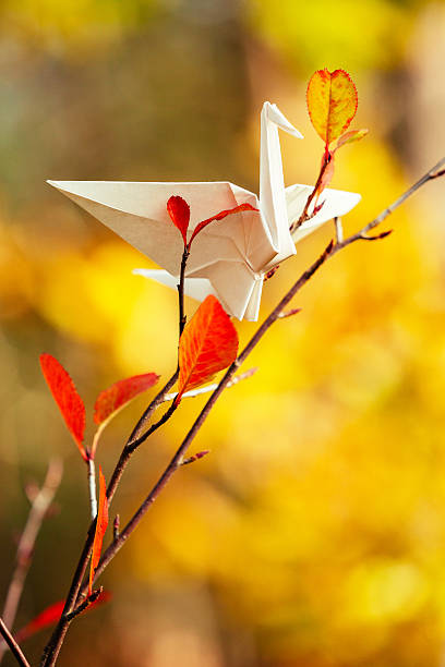 istock Red origami crane on a tree branch 621976994