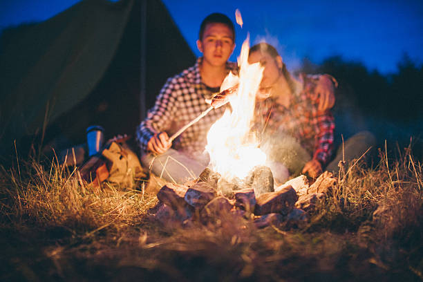 istock Couple preparing sausages on bonfire 621978742