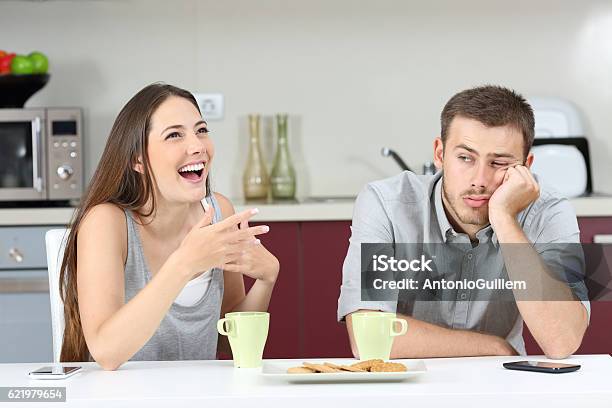 Bored Husband Hearing His Wife Talking Stock Photo - Download Image Now - Boredom, Friendship, Vanity