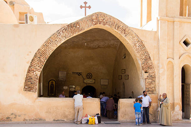 Wadi El Natrun, Egypt - July 20, 2016: Visitors tour the grounds of the Monastery of Saint Bishoy, an ancient Coptic Orthodox Church in Wadi El Natrun.