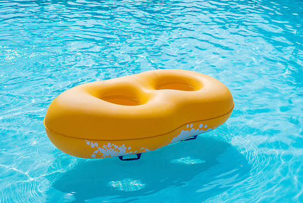 istock Rubber ring yellow floating in the pool 621981596