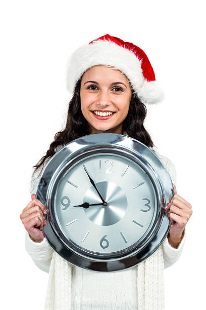 istock Attractive woman with christmas hat holding clock 621982612