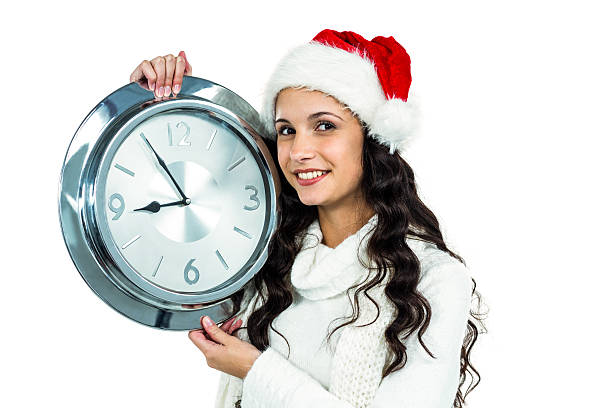 istock Attractive woman with christmas hat holding clock 621982660