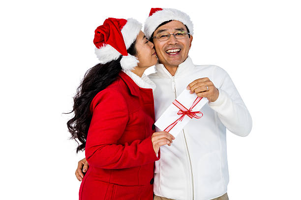 istock Festive senior couple exchanging gifts 621983028