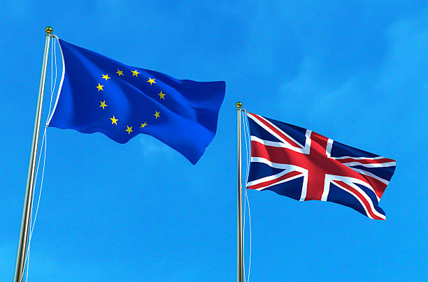istock EU and UK flags on the blue sky background. 621983068