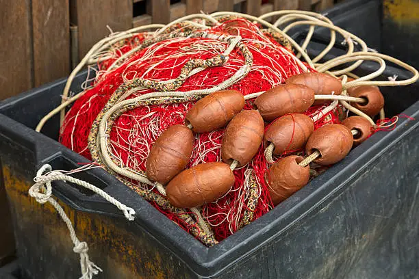 Plastic box full of red white fishing net, huge floats, nylon rope used in fishing industry