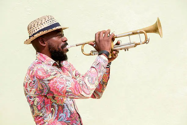Cuban musician playing a trumpet outdoors, Havana, Cuba