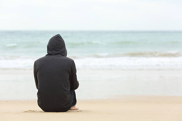 istock Teenager boy thinking watching the sea 621987744
