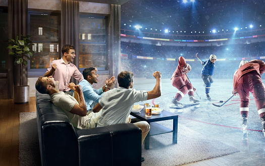:biggrin:A group of young male friends are cheering while watching extremely realistic Ice hockey game at home. They are sitting on a sofa in the modern living room faced to a real stadium with players instead of the front wall. It is evening outside the window.