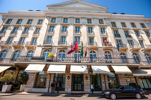 Geneva, Switzerland - May 17, 2014: Four Seasons Hotel des Bergues, Geneva, Switzerland. Car parked at entrance, few people nearby
