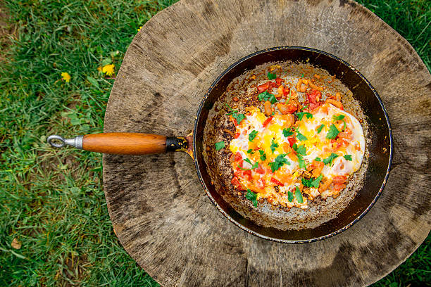 istock Scrambled eggs with tomatoes in a frying pan 621989210