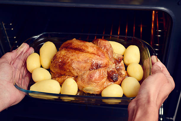 istock young man preparing a roast turkey 621989262