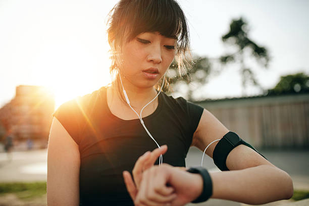 Woman monitoring her progress on smartwatch Close up shot of young sportswoman looking at smartwatch. Fitness female monitoring her progress on smartwatch. watch timepiece photos stock pictures, royalty-free photos & images