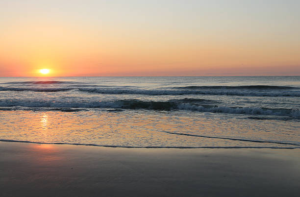 istock The sun rising over the ocean 621990486