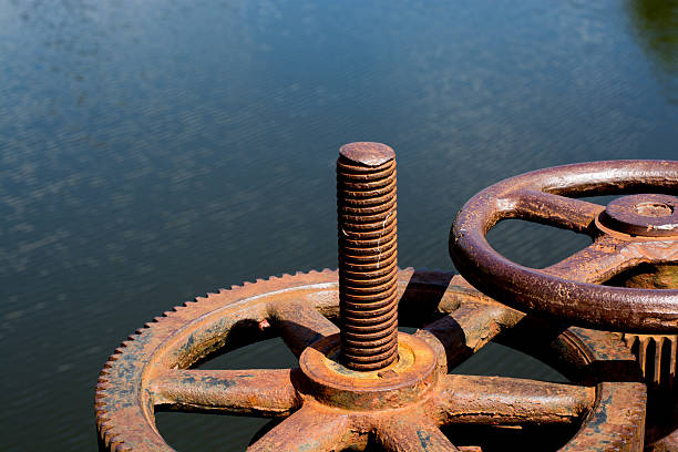 istock Rusted bolts screwed big gear sunlight. It is opening the 621991622
