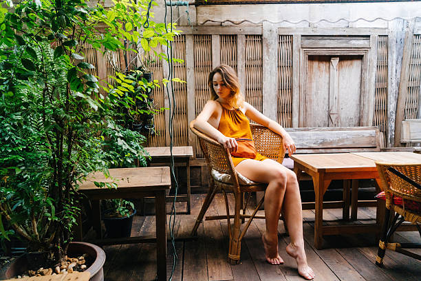 Young Caucasian woman sitting on the chair in patio 